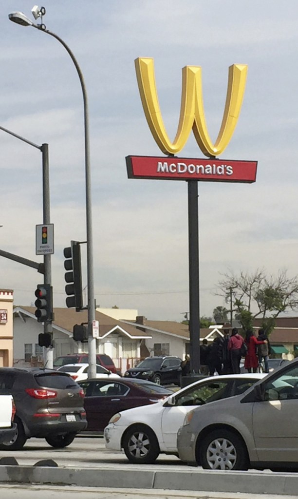 Drivers on Thursday pass a McDonald's restaurant with its Golden Arches flipped in Lynwood, Calif.