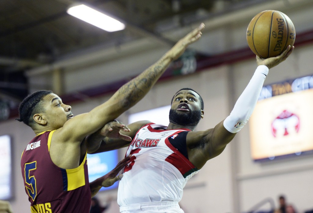 Kadeem Allen of the Red Claws drives past Canton's Arthur Edwards during Maine's 112-103 loss Thursday night at the Expo.