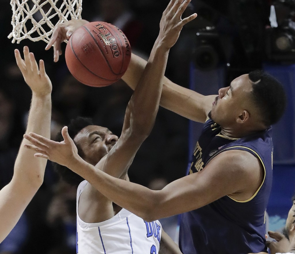 Duke forward Wendell Carter Jr (34) and Notre Dame forward Bonzie Colson (35) battle for a rebound during the first half of an NCAA college basketball game in the Atlantic Coast Conference men's tournament Thursday, March 8, 2018, in New York. (AP Photo/Julie Jacobson)