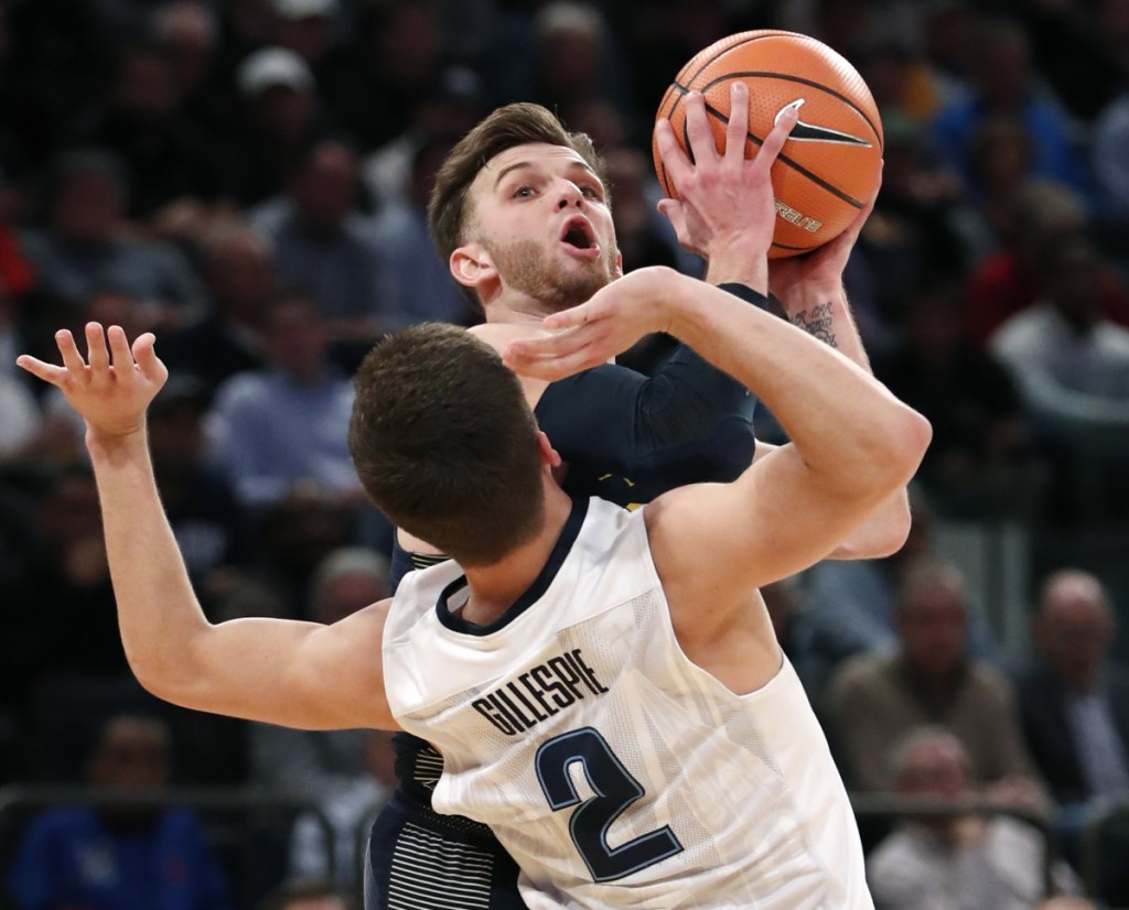 Marquette guard Andrew Rowsey (30) collides with Villanova guard Collin Gillespie (2) during the second half of an NCAA college basketball game in the Big East men's tournament quarterfinal in New York, Thursday, March 8, 2018. Villanova defeated Marquette 94-70. (AP Photo/Kathy Willens)