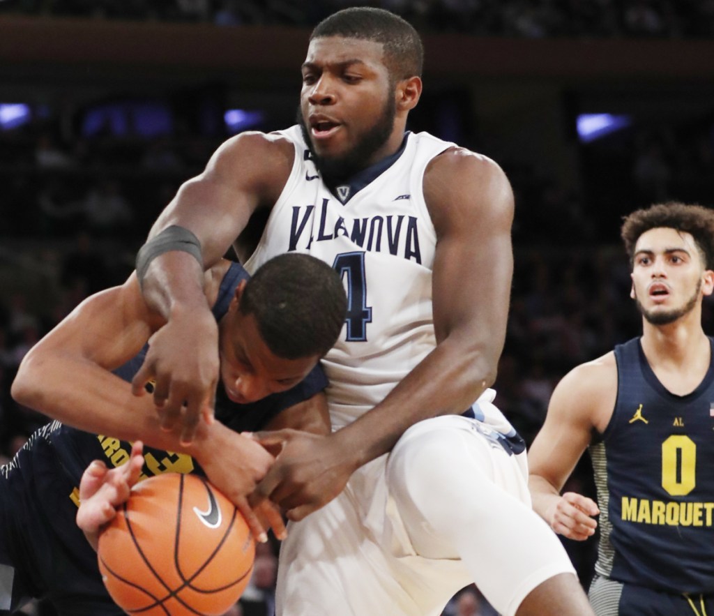Eric Paschall of Villanova tussles for the ball with Jamal Cain of Marquette during the second half of Villanova's 94-70 victory Thursday night in the Big East quarterfinals at New York.