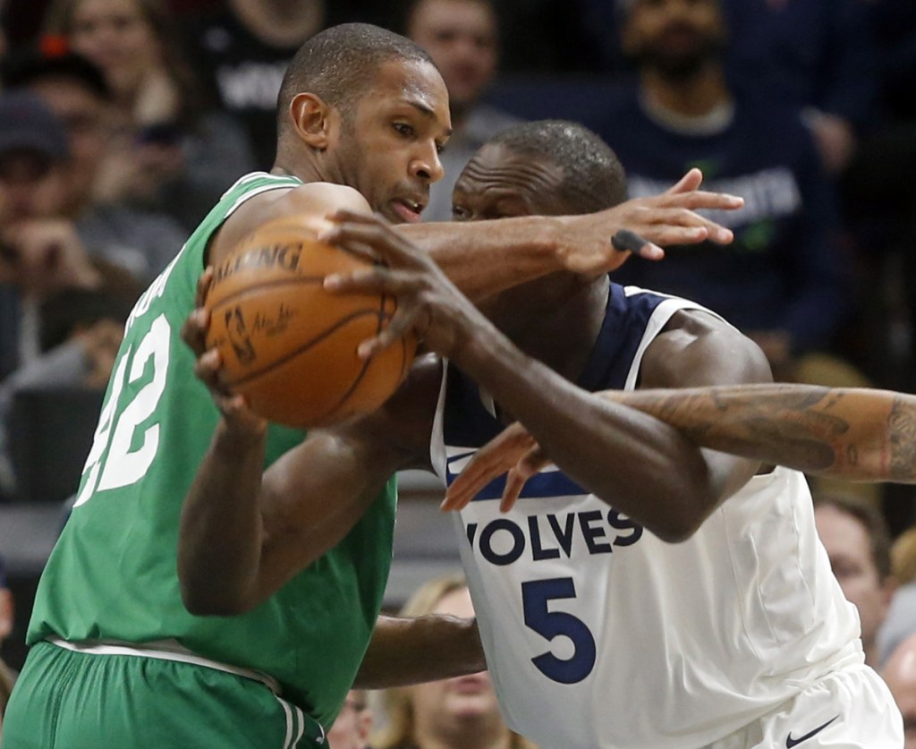 Al Horford, left, of the Celtics defends against Gorgui Dieng of the Minnesota Timberwolves during the first half of the Celtics' 117-109 victory Thursday night.