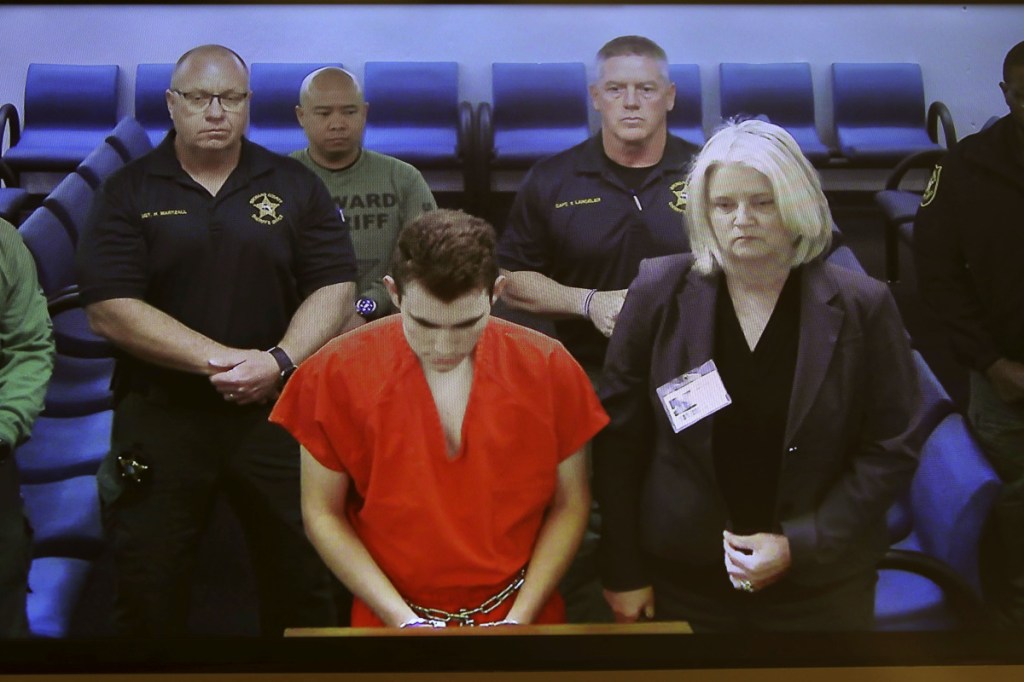 In this image taken from a video monitor, Nikolas Cruz, a former student accused of opening fire at Marjory Stoneman Douglas High School on Feb. 14, appears in magistrate court via video conference from jail on Friday for his initial appearance on attempted murder charges that were added by a grand jury, in Fort Lauderdale, Fla.