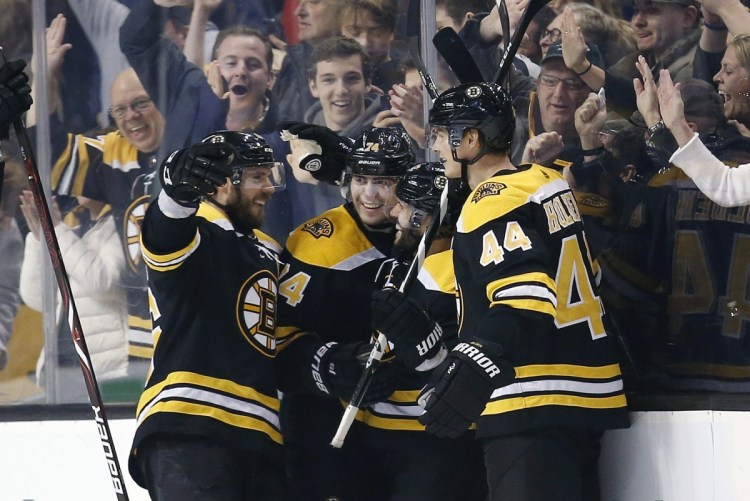 Brian Gionta, second from right, celebrates his goal with teammates, from left, David Krejci, Jake DeBrusk, and Nick Holden during the third period of the Bruins' 7-4 win over the Chicago Blackhawks on Saturday in Boston.