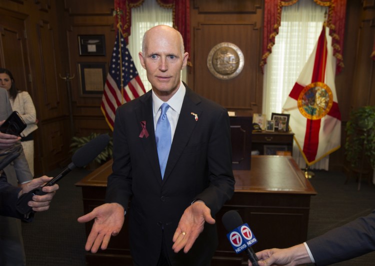 Florida Gov. Rick Scott talks about the Marjory Stoneman Douglas Public Safety Act he signed in Tallahassee on Friday. The law puts some limits on gun purchases and bans bump stocks.