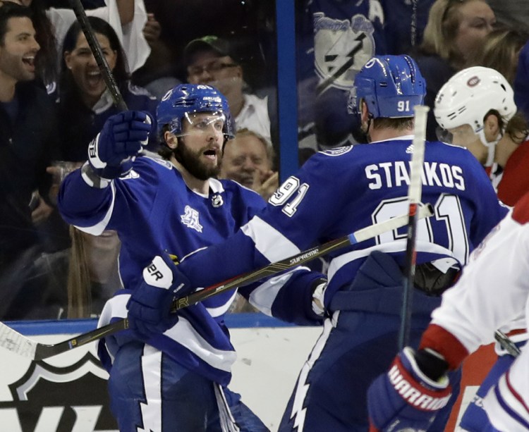 Tampa Bay Lightning right wing Nikita Kucherov, left, celebrates with teammate Steven Stamkos after scoring the tying goal against Montreal in the third period Saturday.