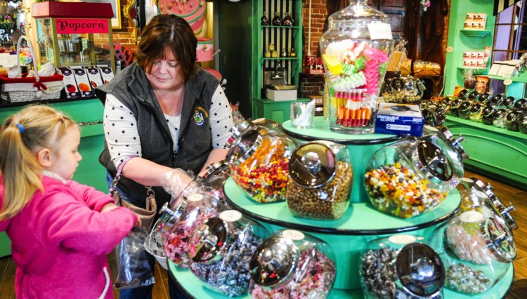 Jaylynn Tenney, 6, and her grandmother Angie Newhouse shop for candy at Scrummy Afters last year on Water Street in downtown Hallowell.