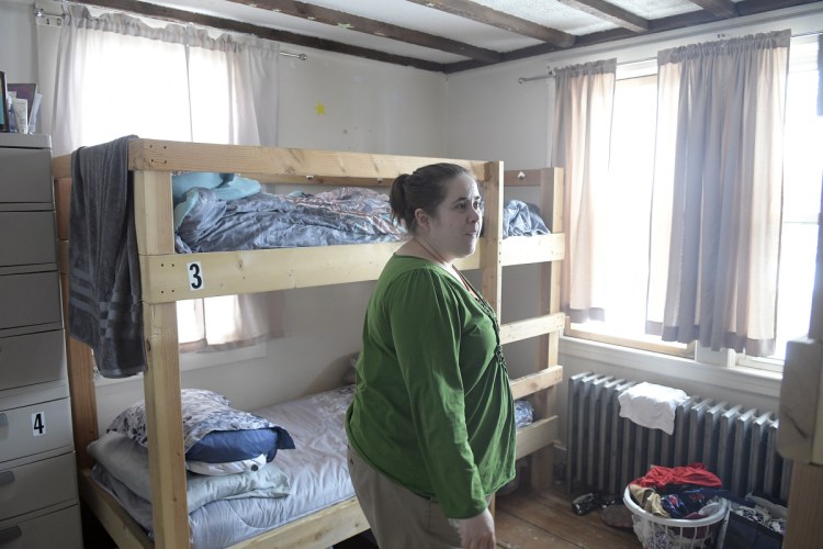 Case manager Jess Talbot walks through a bedroom at the Bread of Life Ministries shelter in Augusta on Monday. The group is planning expansions of its general homeless shelter and its shelter for veterans, which are on adjoining properties on Hospital Street.