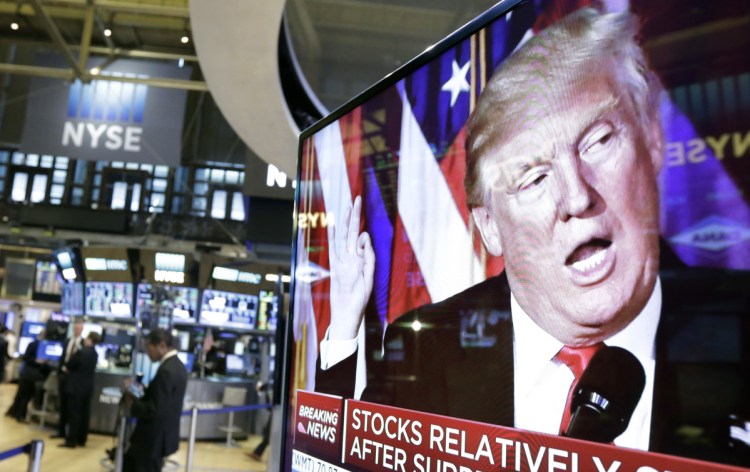 An image of President-elect Donald Trump appears on a TV screen near the floor of the New York Stock Exchange in November 2016. The stock markets have become sensitive to his decisions affecting global trade.