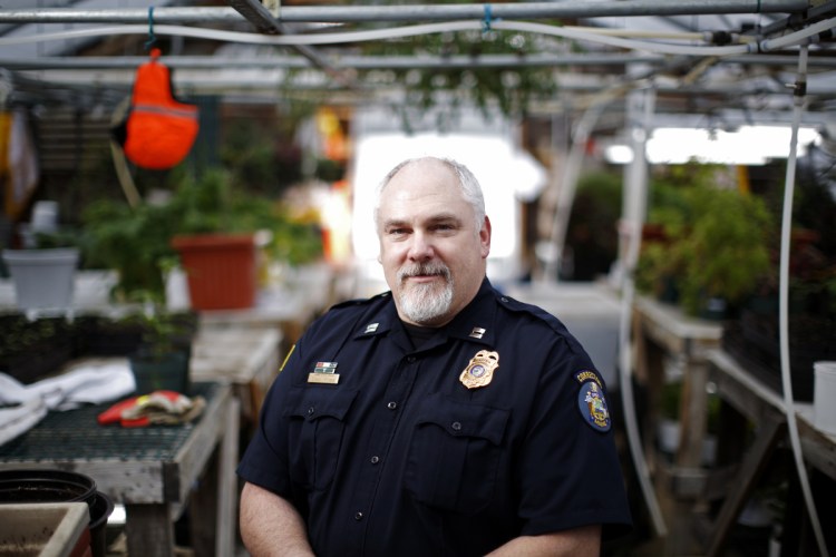 Ryan Fries, a captain at Maine State Prison in Warren, in a greenhouse where inmates work raising plants.