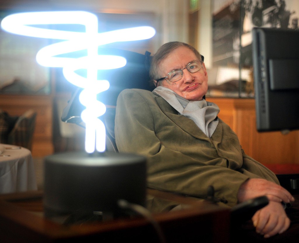 Stephen Hawking poses in 2012 beside a lamp titled "black hole light" by inventor Mark Champkins, presented to him during his visit to the Science Museum in London. Hawking, whose brilliant mind ranged across time and space though his body was paralyzed by disease, died Wednesday, a University of Cambridge spokesman said. He was 76.
(Anthony Devlin/PA via AP)