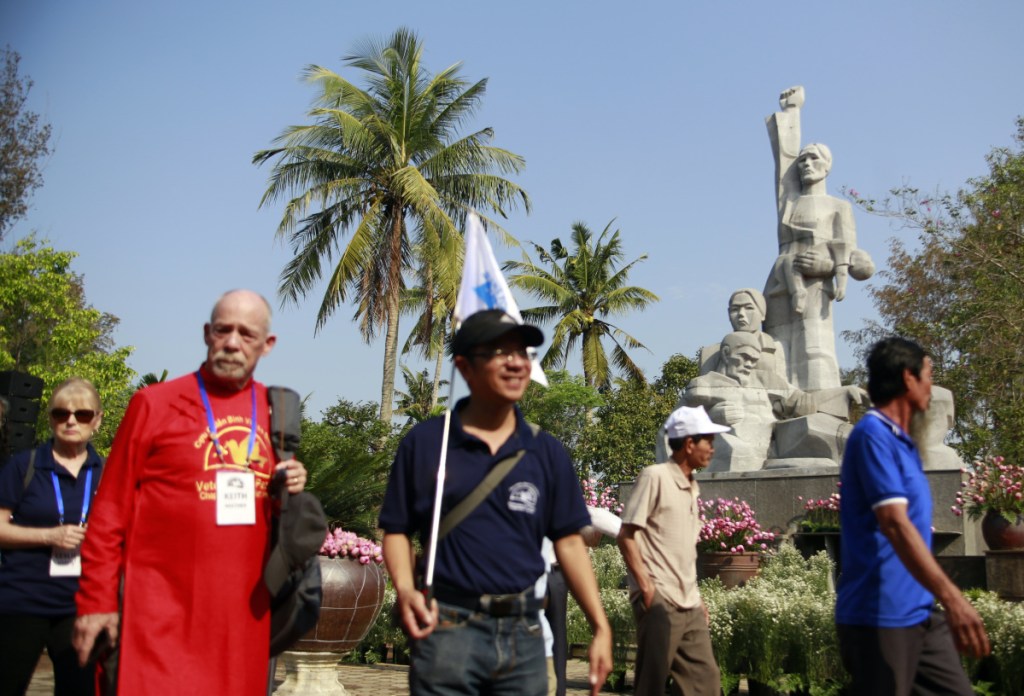 Local residents and American veterans arrive at the My Lai massacre memorial site in My Lai, Vietnam, on Friday.