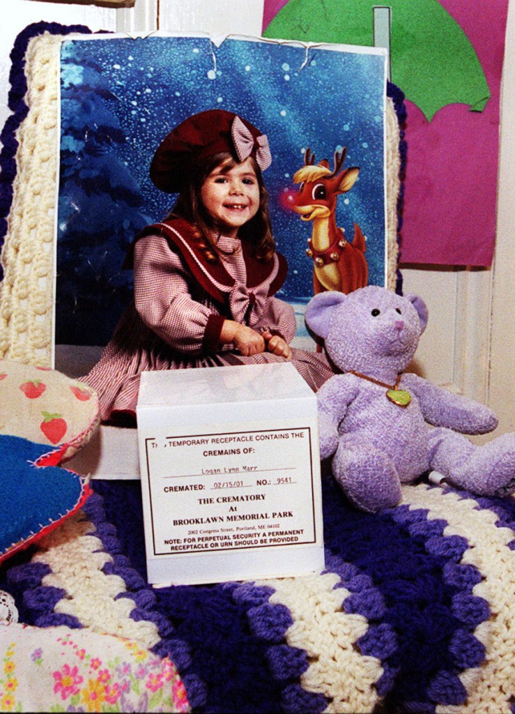 A photo of Logan Marr is part of a memorial set up at her mother's home in 2001 after the 5-year-old was suffocated to death by her foster mother. Maine has a child welfare ombudsman to whom legislators should be listening.