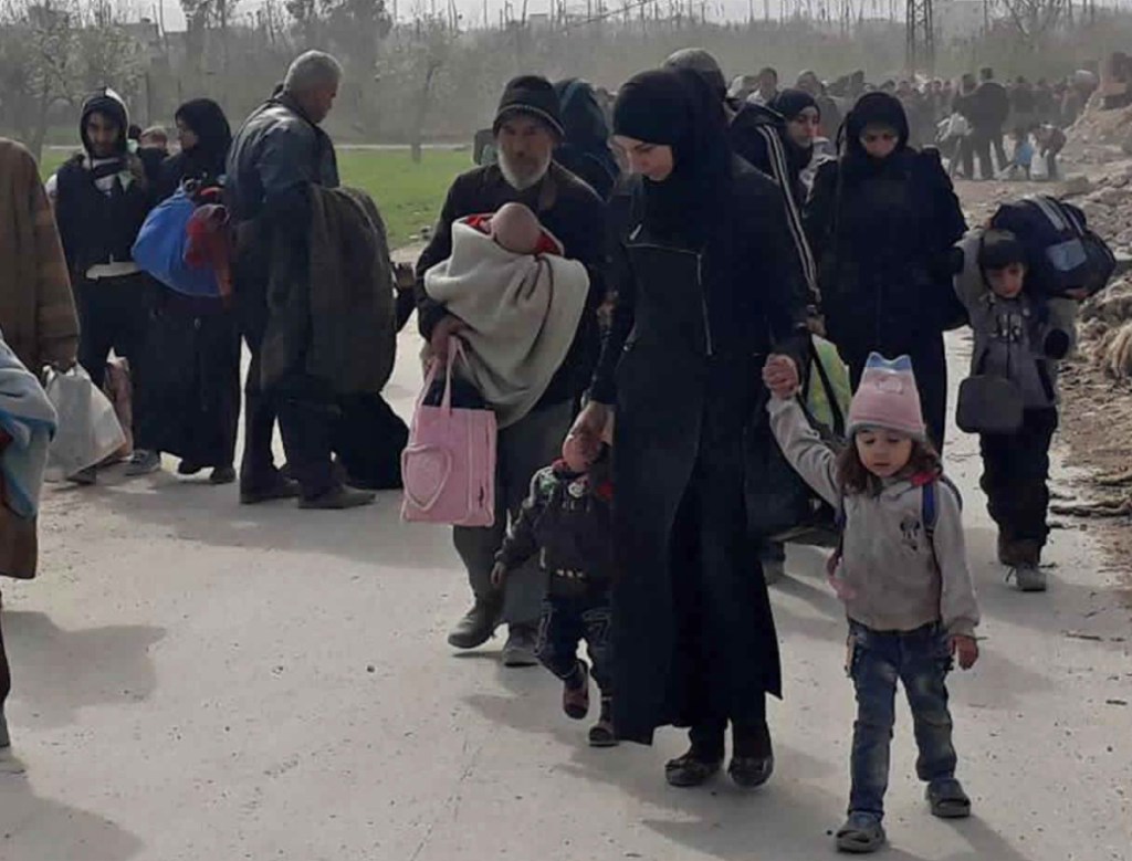 Civilians flee fighting in Ghouta, Syria. A U.N. report says fear of sexual violence drives some families to leave their homes.