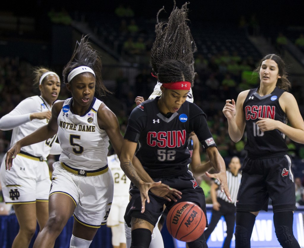 Notre Dame's Jackie Young tries to knock the ball away from Eliza Matthews of Cal State Northridge during Notre Dame's 99-81 victory Friday in South Bend, Indiana.