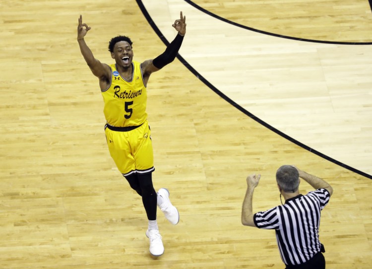 UMBC's Jourdan Grant celebrates after a basket against Virginia during the second half Friday night in Charlotte, N.C. The Retrievers won the game, 74-54.