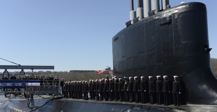 The crew of the fast-attack submarine USS Colorado man the rails Saturday during a commissioning ceremony at the Naval Submarine Base New London in Groton, Conn.