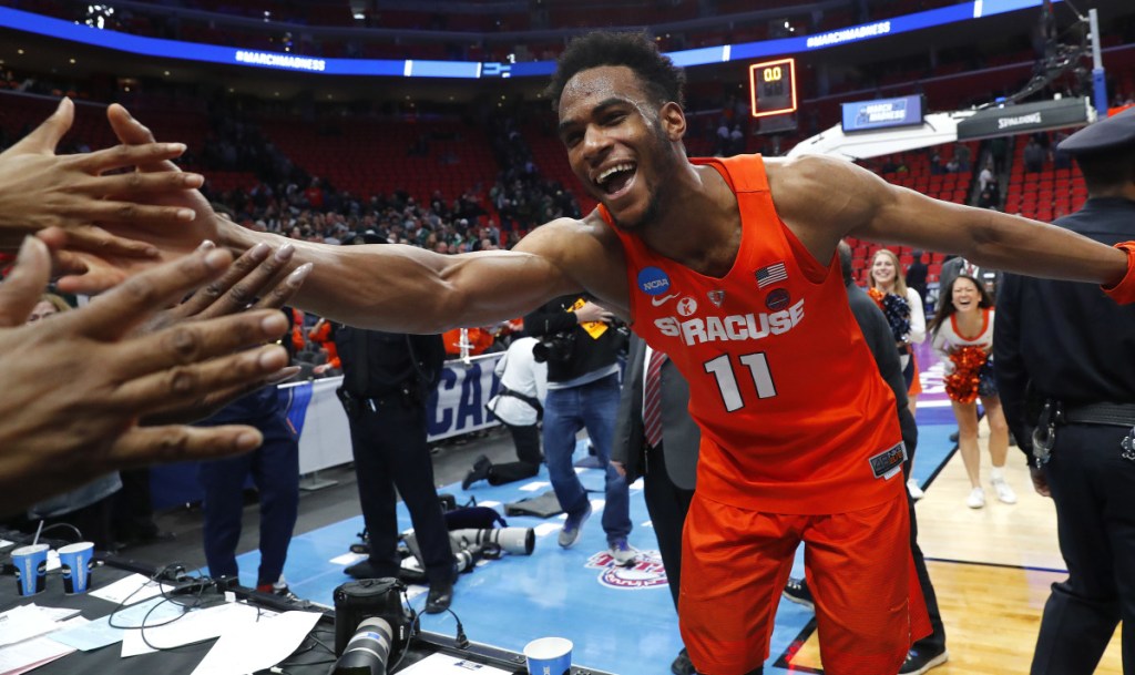 Oshae Brissett of Syracuse celebrates with fans Sunday after the Orange – the final at-large team selected for the NCAA tournament – upset Michigan State 55-53 to advance to the regional semifinals and a game against Duke.