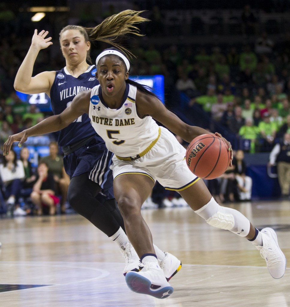 Jackie Young of Notre Dame drives by Adrianna Hahn of Villanova during their second-round game of the NCAA women's basketball tournament Sunday night. After a halftime tie, Notre Dame pulled away to a 98-72 victory.