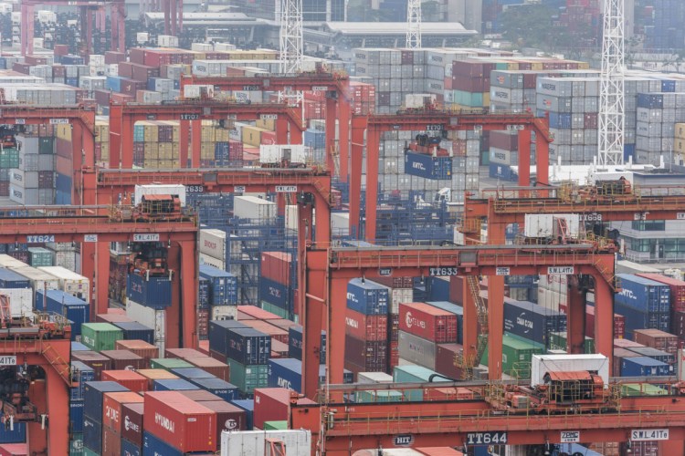 Shipping containers sit stacked among remote-controlled gantry cranes at Kwai Tsing Container Terminals in Hong Kong. The Trump administration is preparing new tariffs on Chinese imports.