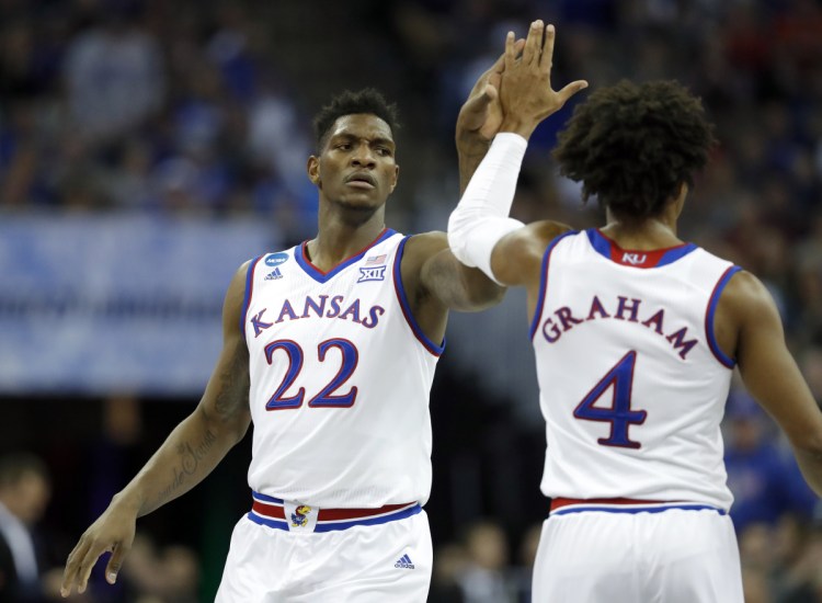 Silvio De Sousa celebrates with Kansas teammate Devonte Graham during an 80-76 victory Friday night against Clemson in Omaha, Nebraska. The top-seeded Jayhawks will play Sunday for a spot in the Final Four.