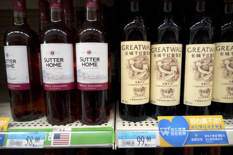 Wine from the United States is displayed next to Chinese wine at a supermarket in Beijing. China announced a $3 billion list of U.S. goods including pork, apples and steel pipe on Friday that it said may be hit with higher tariffs in a spiraling trade dispute with President Donald Trump that companies and investors worry could depress global commerce.