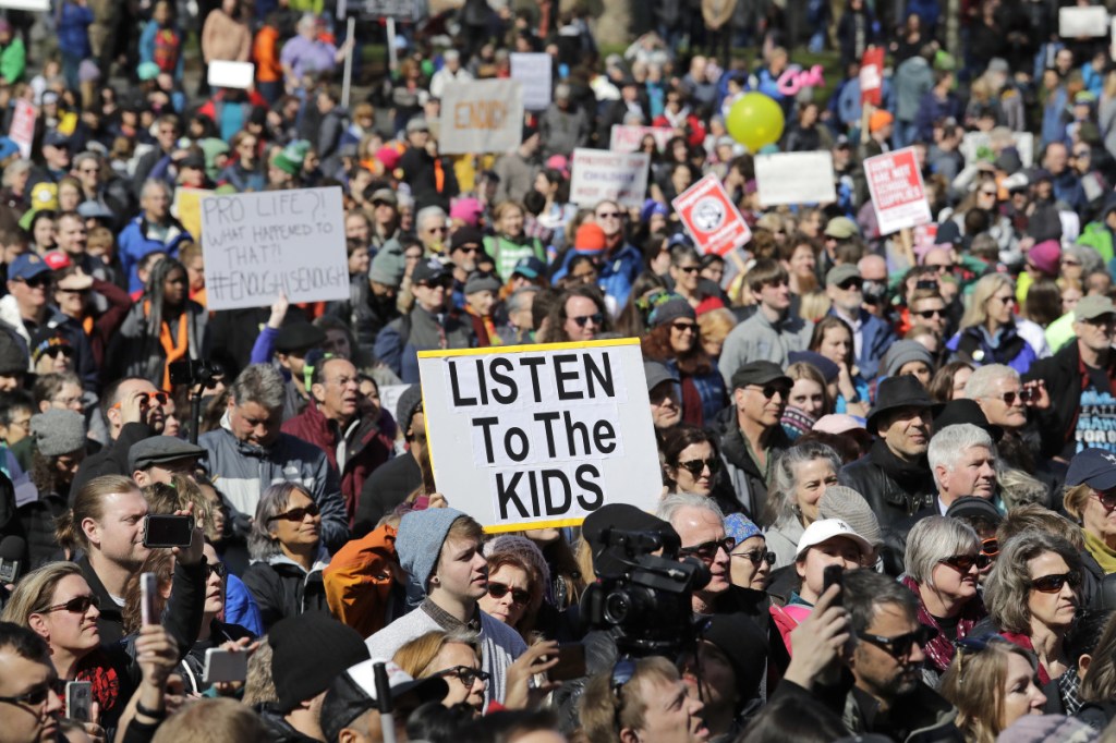 Thousands of protesters look at at a rally following a march in favor of gun control at the Seattle Center Saturday, March 24, 2018, in Seattle. Summoned to action by student survivors of the Florida school shooting, hundreds of thousands of teenagers and their supporters rallied in the nation's capital and cities across America on Saturday to press for gun control in one of the biggest youth protests since the Vietnam era.