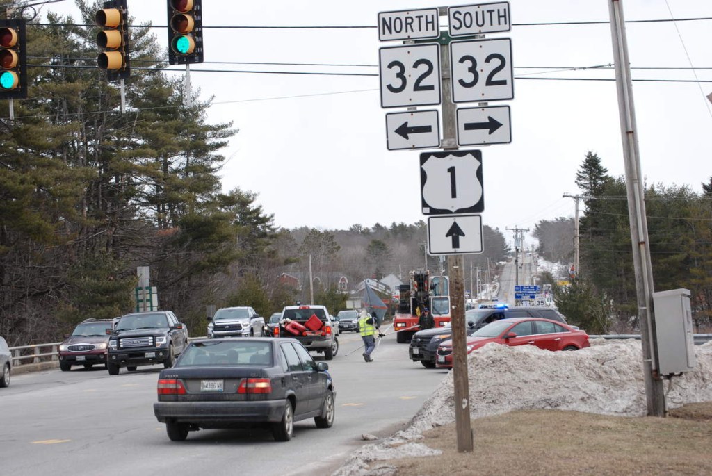 The intersection of Route 1 and Route 32 in Waldoboro begins to be cleared after the removal of a vehicle that was discovered upside down in the Medomak River early Sunday. The single occupant died in the crash.