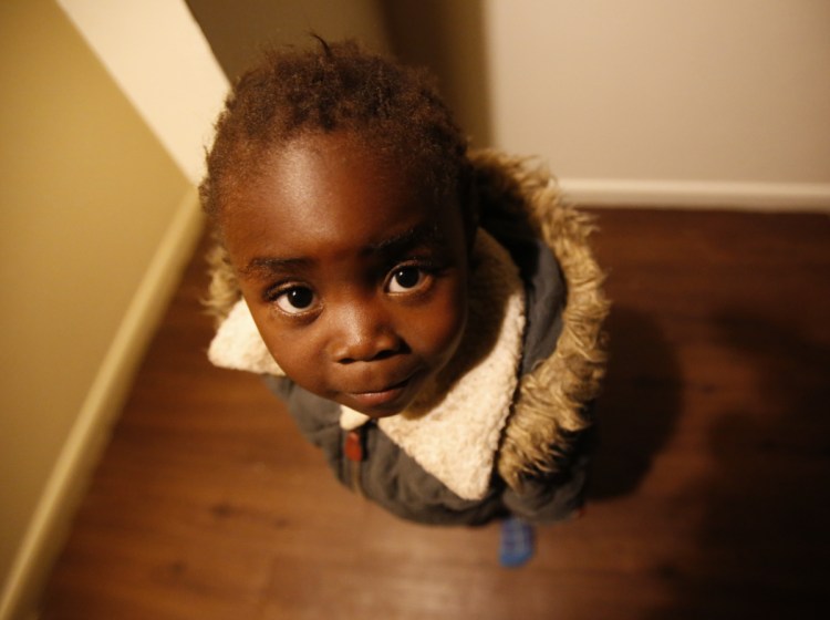 Moza Ausa, a 4-year-old refugee from the war-torn Democratic Republic of Congo, stands in the family's new apartment in Columbus, Ohio, in February.
