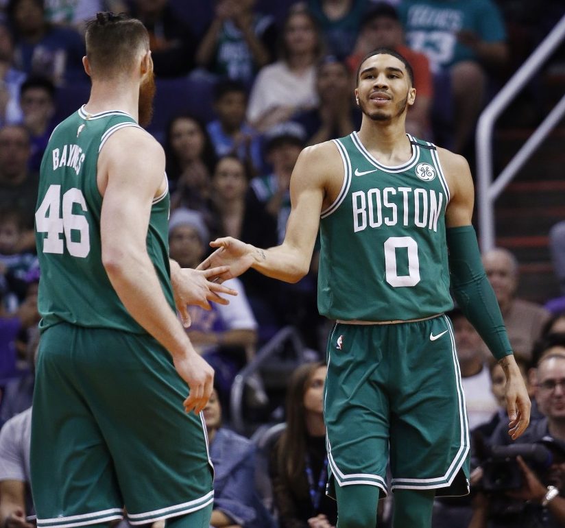 Celtics rookie Jayson Tatum, right, slaps hands with center Aron Baynes during the second half of Boston's 102-94 victory at Phoenix on Monday night. Tatum led Boston with 23 points. (AP Photo/Ross D. Franklin)