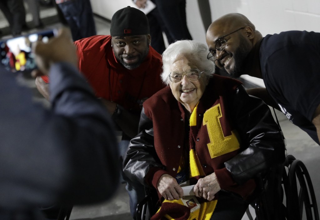 Loyola-Chicago basketball chaplain Sister Jean Dolores Schmidt, poses with fans for a photo before the first half of the NCAA regional final in Atlanta on Saturday. (AP Photo/David Goldman)