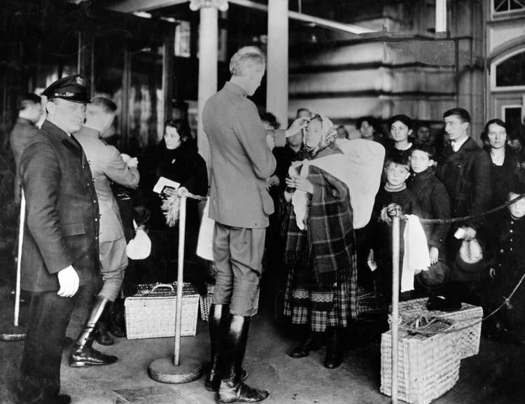 Doctors check immigrants arriving at Ellis Island for signs of illness in 1910. A recent Maine Voices calling for greater immigration limits cites the same arguments used to justify earlier quotas on immigration from southern and eastern Europe, a reader says.