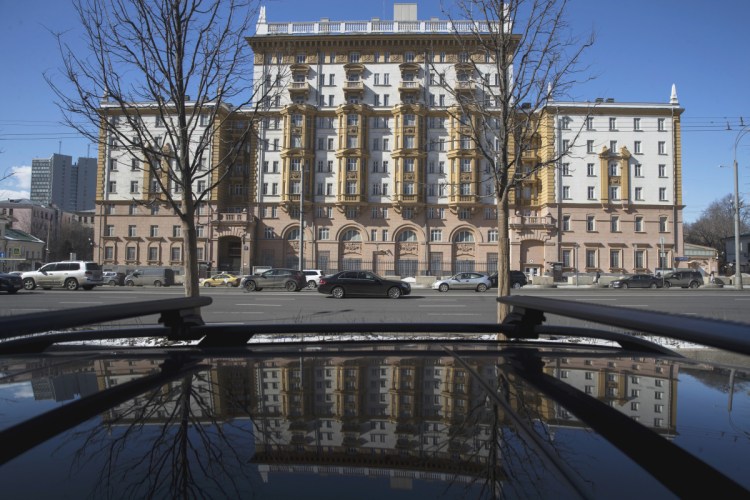 The U.S. Embassy is reflected in a car in Moscow, Russia, on Thursday. Russia is kicking out U.S. diplomats in response to Monday's coordinated expulsion of Russian diplomats from the United States and a number of European countries, Foreign Minister Sergei Lavrov said Thursday.