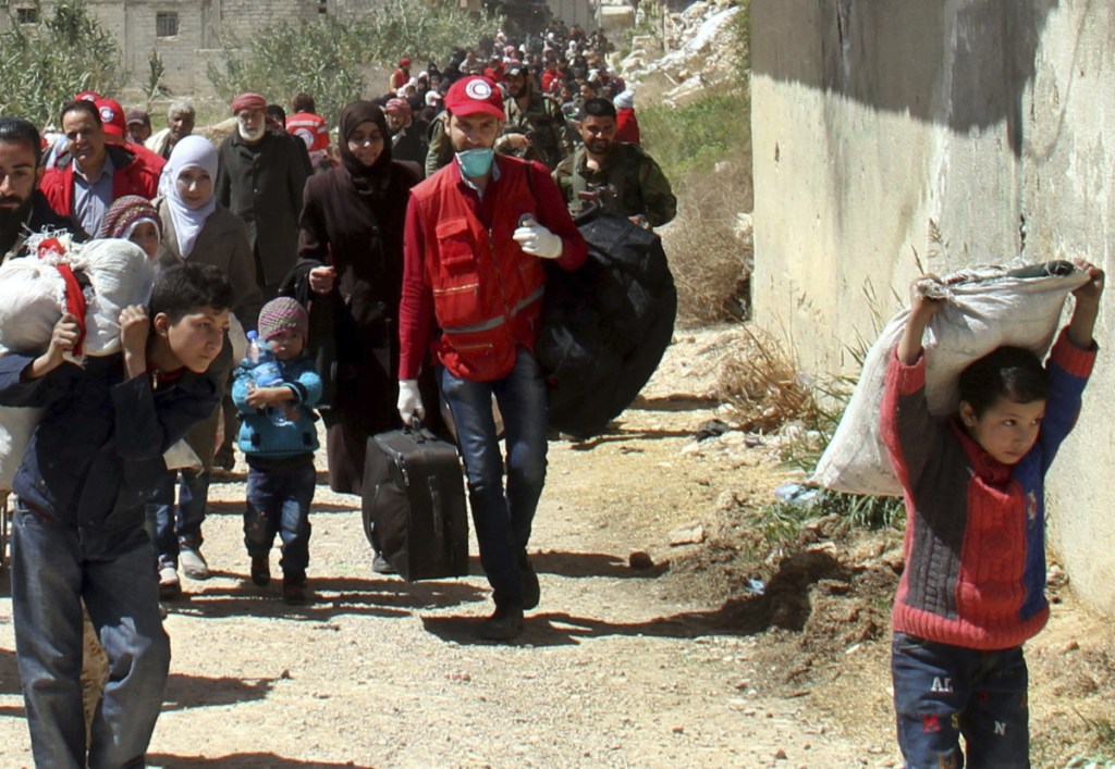 Carrying their belongings, civilians leave their homes in the eastern Ghouta region near Damascus, Syria, on Sunday.