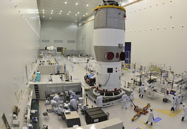 Chinese scientists and technicians test the Tiangong-1 at the Jiuquan Satellite Launch Center in northwest China's Gansu Province prior to its launch on Sept. 29, 2011.