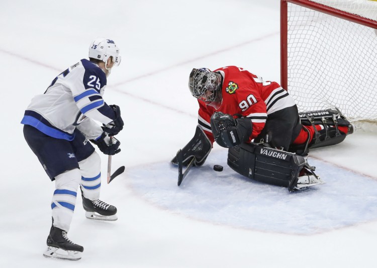 Chicago Blackhawks goalie Scott Foster defends against Winnipeg Jets center Paul Stastny  during the third period of an NHL hockey game on Thursday.