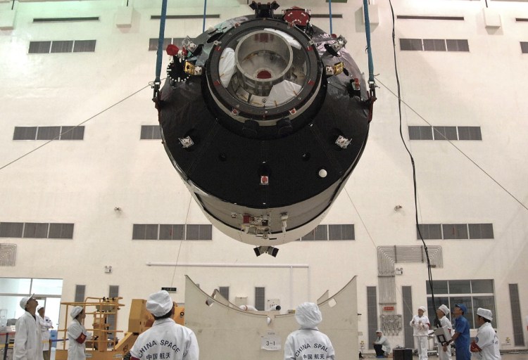 Researchers install China's first space station module Tiangong 1 at the Jiuquan Satellite Launch Center in China's Gansu Province prior to its launch on Sept. 29, 2011.