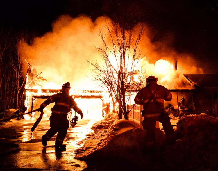 Firefighters from Greene, Monmouth, Wales and other towns work on March 19 at the scene of a house fire on Patten Road in Greene, one of three that occurred in the Androscoggin County town in March. From left are Wales firefighter Garrett Gile and Wales Fire Chief Anthony Siderio Sr.