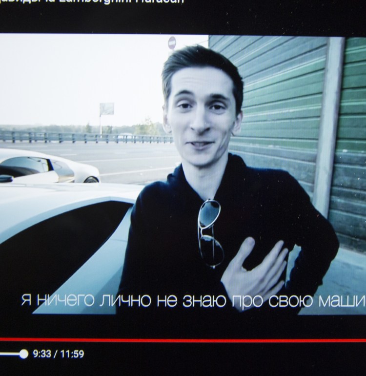 A tablet shows archive Youtube footage dated Aug. 2, 2015, featuring Yevgeniy Nikulin.