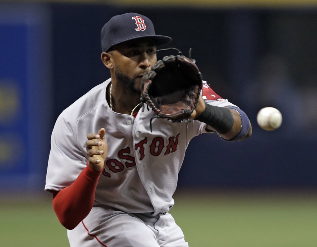 Red Sox third baseman Eduardo Nunez fields a ground ball by Tampa Bay's Carlos Gomez during the first inning Saturday in St. Petersburg, Fla. The Red Sox improved to 2-1 with a 3-2 victory.