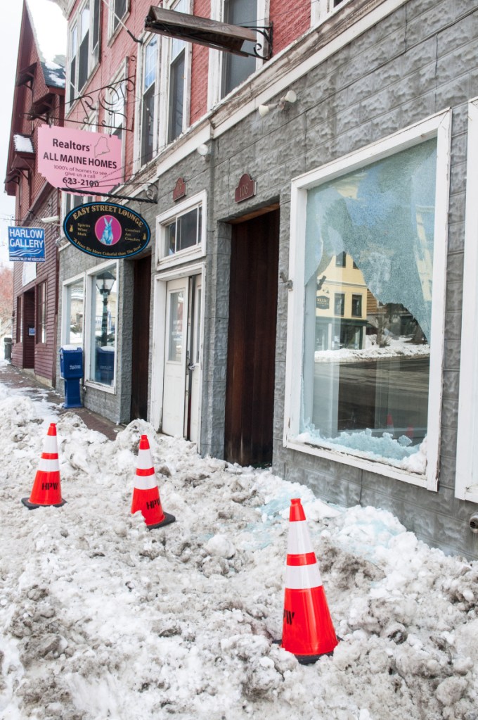 Damage to the window of unoccupied store front at 106 Water St. is seen Thursday in downtown Hallowell. Earlier in the morning, a hit-and-run driver of a tractor trailer failed to stop at intersection of Water and Winthrop Streets then struck a street light, which broke the window.