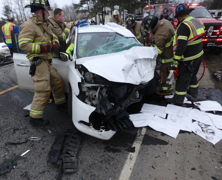 A crew from Winslow Fire and Rescue work to extricate Amos Christiansen Wednesday evening from his 2014 Nissan Sentra following a head-on collision on Augusta Road in Winslow. Police say Christiansen may have fallen asleep at the wheel, causing him to cross the center lane into oncoming traffic.