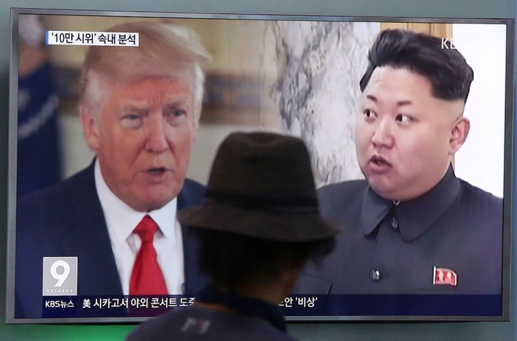 A television screen in Seoul, South Korea, shows President Trump and North Korean leader Kim Jong Un during a news program in August. South Korea's national security director said Thursday that the two will meet "by May."