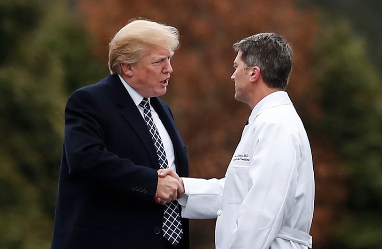 President Donald Trump shakes hands with White House physician Dr. Ronny Jackson after his first medical check-up as president in January.