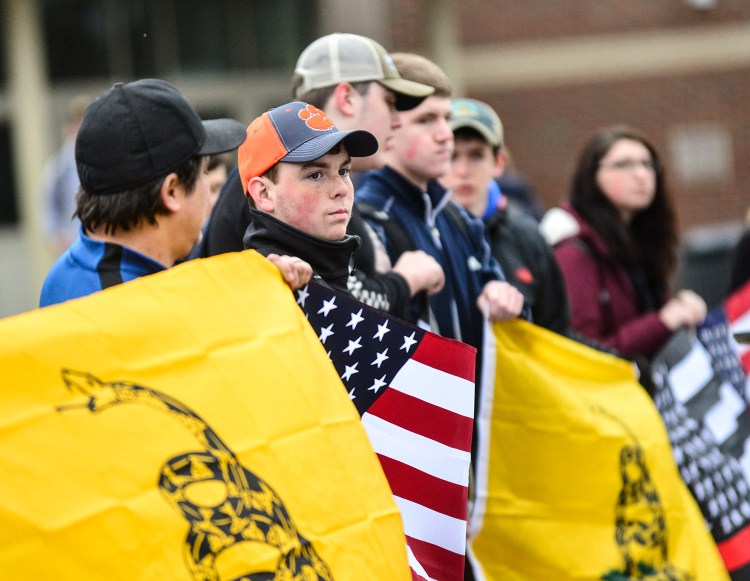 More than two dozen students and citizens gather outside Brattleboro Union High School in Brattleboro, Vermont, on Friday before the start of classes to hold a rally in support of the Second Amendment and gun rights. The Vermont Legislature approved new gun restrictions Friday.