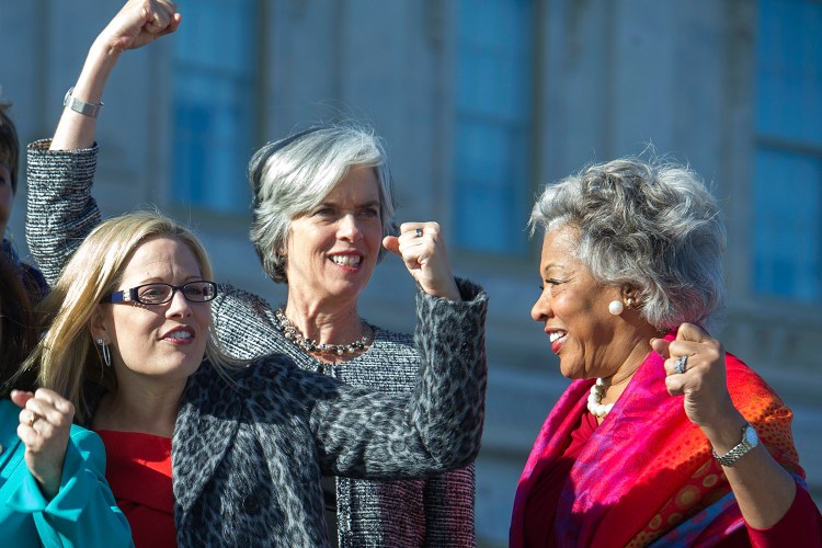 From left, Rep. Kyrsten Sinema, D-Ariz., Rep. Katherine Clark, D-Mass., and Rep. Joyce Beatty, D-Ohio, shown in January 2017, raise fists to show unity on Capitol Hill in Washington. Sinema is running for the Senate.