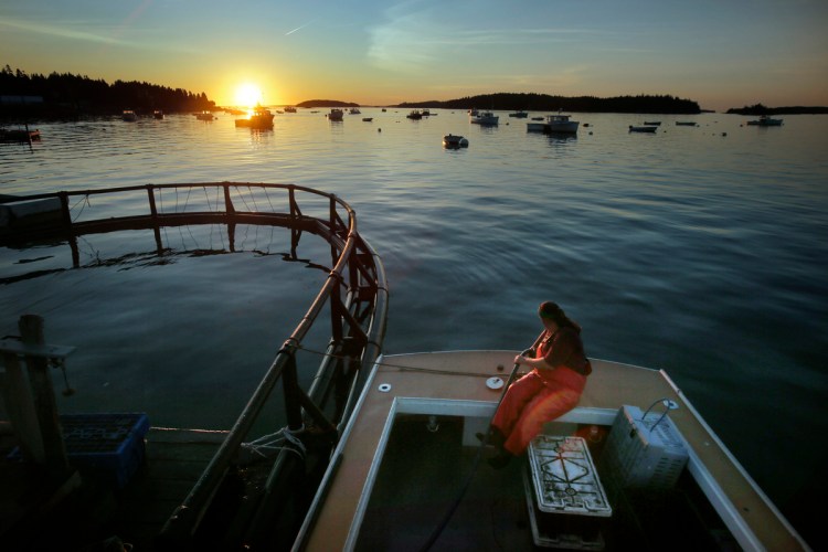 Genevieve McDonald fills up her lobster boat with gas before heading out for a day of lobstering off the coast of Stonington. The best lobstering used to be in Casco Bay in the 1980s but has shifted east and is now considered to be in and around Stonington. "We're definitely seeing this geographic shift and its in keeping with the warming of the gulf," says Robert Steneck, a lobster expert at  the University of Maine's Darling Marine Center. 