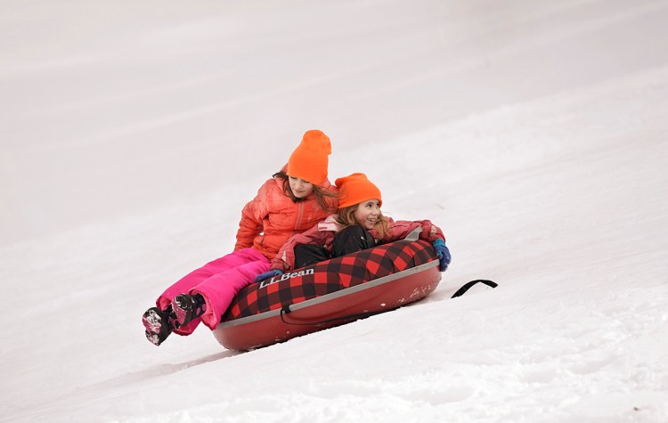 With school canceled in RSU 21, Addison Carbone, 10, left, and her sister Tamryn, 7, had time to sled in Kennebunk on Wednesday, March 14, 2018. Due to the number of snow days and, for some districts, the power outages last fall, the last day of school for many districts has been pushed into late June. 