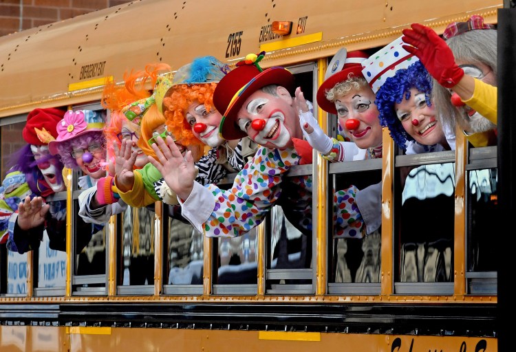 World Clown Convention attendees wave to fellow clowns at the annual gathering in Bloomington, Minn. 