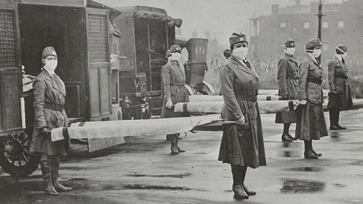 St. Louis Red Cross Motor Corps personnel prepare to transport victims of the 1918 influenza epidemic. 